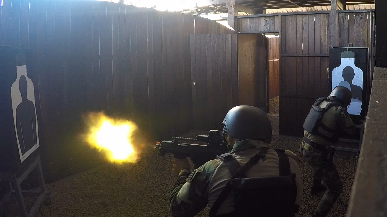 An Uraguayan competitor fires his weapon during a simulated hostage rescue mission July 22, 2017, during Fuerzas Comando in Cerrito, Paraguay. Teams must work together to take out all the enemy targets and rescue a hostage from captivity. Fuerzas Comando aims to improve partnerships among competing countries. (U.S. Army photo illustration by Pfc. Lauren Sam/Released) (This image was created by capturing a still frame from a video.)